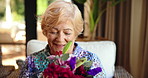 Senior woman, flowers and love with smile for floral bouquet, gift or secret admirer at retirement home. Elderly, female person or happy with bloom, blossom or plants for mothers day at old age house