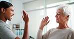 Happy woman, senior and high five with physiotherapist for success, winning or good news at clinic. Elderly, female person or client with healthcare worker for thank you or well done at hospital