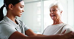 Senior woman, stretching arms and physiotherapist for checkup, injury progress and medical advice. Elderly patient, helping and physiotherapy of mobility assessment, rehabilitation and healing muscle