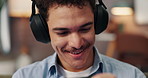 Cellphone, headphones and man on sofa playing video games online in living room for entertainment. Happy, relax and male person with phone for watching movie on social media with audio tech in house.