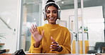 Happy woman, face and video call with wave for webinar or presentation at office desk. Portrait, female person or creative employee with headphones for online communication or discussion at workplace
