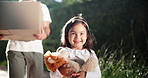 Walking, smile and child with father for real estate, property relocation and stuffed animal with box. Kid, happy girl and dad moving for mortgage, loan and hands carrying package in backyard outdoor