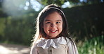 Girl, child and smile outdoor on face in garden with development, fashion and happiness. Portrait, female kid and excited in nature for holiday with innocence and confidence of positive youth