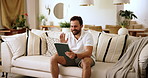 Tablet, relax and man on sofa in home for reading online newsletter for political information. Happy, digital technology and male person with research for election results on app in living room.