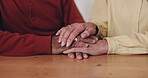 Old couple, holding hands and support with comfort in home for grief, healing and empathy in retirement. Closeup, elderly people and trust with compassion, sympathy and bonding with care and love