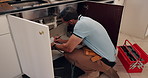 Inspection, maintenance and toolbox with plumber in kitchen of home for repair of pipes or water flow. DIY, upgrade and wrench with man in apartment for evaluation, renovation or service of system
