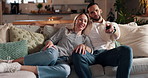 Happy couple, relax and watching tv on sofa for movie, show or streaming entertainment at home. Man, woman or lovers with smile on couch for humor, bonding or comedy series in living room at house