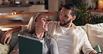 Relax, smile and tablet with couple on sofa in living room of home together for evening bonding. App, social media or streaming with man and woman in apartment at night for internet browsing