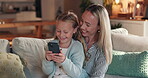 Mother, daughter and laughing with smartphone in home, happy together for games or funny video online. Bonding, love and comedy cartoon with woman and girl on sofa in family house for streaming app