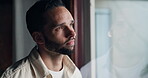 Sad, thinking and window with man at home for mental health, memory and psychology. Mistake, fear and loneliness with male person in living room of house for depression, grief and reflection