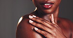 Studio, black woman and skincare with oil for shoulder, dermatology and clean shine for wellness. Female person, glow and dropper with serum for facial cosmetics, hyaluronic acid by gray background