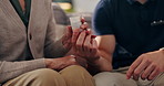 Hands, home and nurse with old woman, pills or advice with wellness, senior medication or recovery. Closeup, caregiver or elderly person on sofa, tablets or prescription drugs with healthcare or help