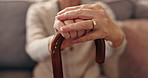 Senior woman, hands and cane in home for balance, support and retirement. Walking stick, elderly and person with disability in living room, osteoporosis and medical recovery for mobility with closeup