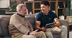 Tablet, medical and caregiver with senior man in nursing home for healthcare consultation. Digital technology, discussion and male person with elderly patient for explaining treatment plan in house.
