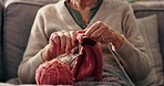 Hobby, hands and senior woman knitting in home for mental engagement, activity or creativity. Closeup, retirement and elderly female person with needles and wool for handmade clothes in living room.