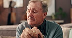 Home, thinking and senior man with walking stick, sad and grief with retirement, loss and anxiety. Apartment, pensioner and elderly person on sofa, cane and mental health with nostalgia and memory