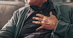 Sofa, old man and hands on chest for pain, cardiac symptoms and heart attack signs in retirement. Home, senior person and discomfort with respiratory illness, viral infection or tuberculosis on couch
