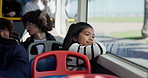 Happy girl, relax and bus with window view for travel, destination or journey in city. Child, kid or thinking with vision or reflection for public transportation, travel or sightseeing in vehicle