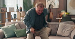 Senior man, walking stick and sofa in home with back pain, steps and recovery from injury in retirement. Elderly person with disability, cane and rehabilitation for spine in living room at house