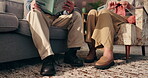 Knitting, reading and senior couple in home, legs and elderly patient with skills for crochet and retirement. Bonding, old people and relax in living room with book, feet and commitment in house