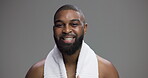 Towel, beauty and face of black man in studio for shower, hygiene and grooming. Hairstyle, self care and cosmetics with portrait of person on gray background for skincare, salon and dermatology