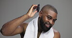 Brush, beauty and face of black man in studio for shower, shampoo and grooming. Hairstyle, self care and cosmetics with portrait of person on grey background for barber, scalp and dermatology