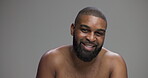 Skincare, smile and face of black man in studio for glow hygiene and grooming. Shine, self care and cosmetics with portrait of male person on gray background for model, salon and dermatology
