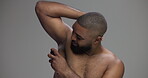 Studio, black man and armpit with deodorant for hygiene, sweat and body wellness with confident face. Mockup, person and happy with antiperspirant for fragrance, fresh or self care by gray background