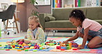 Building blocks, children and friends on floor in home for cognitive development or creativity. Learning, living room and girl kids with educational toys for fine motor skills or sensory play.
