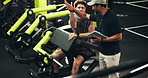 Tablet, exercise and men in gym, high five and support with challenge, training and personal trainer. People, instructor and bodybuilder with tech, hand gesture and app for progress or muscle growth