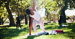 Yoga, class and instructor stretching outdoor with side plank pose for core strength, wellness or posture guidance. Pilates, yogi and people with holistic exercise at park for balance and mindfulness