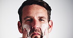 Man, skincare and apply cream on face for skin moisturizer, morning routine and spf protection. Cosmetics, person and lotion for self care, hydration treatment and dermatology on studio background