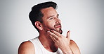 Studio, routine and man with beard, touch and smile for fresh shave, grooming and facial treatment. White background, self care and person with happiness for haircare, mockup space and guy in morning