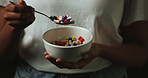 Hands, bowl and pills for abuse in studio with eating for mind altering drugs by black background. Person, capsule and illegal tablet with opioid crisis, addiction and spoon with chemical compound