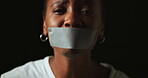 Face, fear and black woman with tape in studio on dark background for gender equality or domestic violence. Portrait, silence or abuse and scared female victim with mouth covered for censored voice