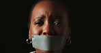 Face, stress and black woman with tape in studio on dark background for gender equality or domestic violence. Portrait, silence or abuse and scared female victim with mouth covered for censored voice