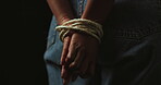 Hands, rope and prisoner or hostage and escape isolated on black background. Freedom, fear and danger of person with censorship, bondage and domestic violence with anxiety, depression or crime