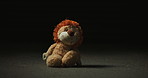 Abandoned, lost and adoption fail with toy in studio for loneliness, depression and grief. Foster care rejection, stuffed animal and mental health with lion on dark background for fear and mourning