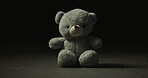 Abandoned, lost and adoption fail with teddy bear in studio for loneliness, depression and grief. Foster care rejection, stuffed animal and mental health with toy on dark background for fear