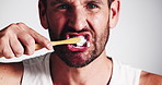 Toothbrush, dental hygiene and face of man in studio for brushing teeth, health or morning routine. Oral care, cleaning and portrait of person with treatment for plaque removal by white background.