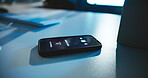 Mobile, phone and screen with incoming call on desk with private number, phishing scam and telemarketer. Night, ringing and smartphone with unknown contact for cyber security, scammer or notification