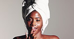 Black woman, face and sugar scrub on lips for beauty treatment, skincare or natural exfoliation. Portrait, mouth and model apply facial cosmetics for glow, peeling or clean on white studio background