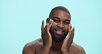 Cream, beauty and face with black man in studio for skincare cosmetics, dermatology or self care. Lotion, glow and male grooming with person on blue background for hydration, collagen and moisturizer