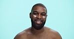 Cream, skincare and face with black man in studio for beauty cosmetics, dermatology or self care. Lotion, glow and male grooming with person on blue background for hydration, collagen and moisturizer