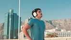Fitness, man and getting ready with headphones in city to start running, marathon training or workout podcast. Runner, breathe or listening to music outdoor for cardio, exercise performance or health
