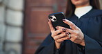 Research, lawyer and woman with smartphone, outdoor and online for case on website, low angle and typing. Browsing, advocate and mature person with mobile for lawsuit, digital and legal info in city