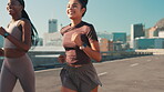 Running, friends and fitness with woman in city for marathon training, health and race team. Energy, competition and exercise with people in street for sports athlete, workout and wellness together