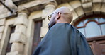 Walking, judge and man in city for law, journey and leaving magistrate court building in low angle. African person, lawyer and travel outdoor for legal practice, judicial and commute for justice