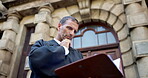 Thinking, reading and judge or man in city for trial report, policy legislation and legal documents. Lawyer idea, attorney paperwork and vision with mature person at courtroom low angle for file