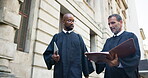 Judge, paperwork and lawyer discussion outdoor for legal case planning, criminal investigation and bail decision. Teamwork, people or walking by city courthouse with file for trial research or advice